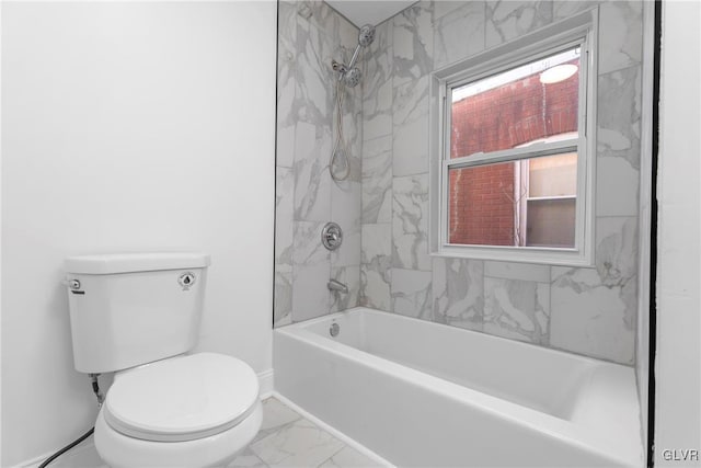 bathroom featuring toilet and tiled shower / bath