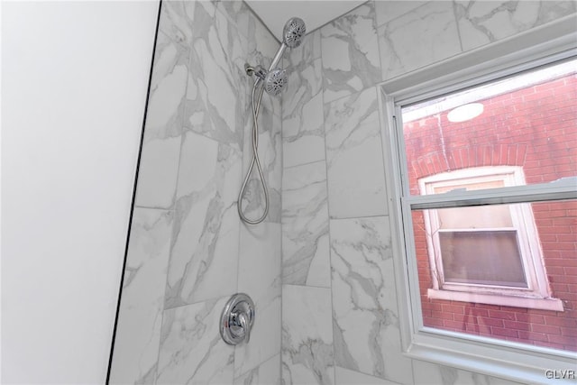 interior details featuring tiled shower