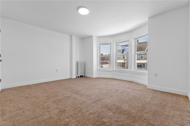 carpeted empty room with radiator