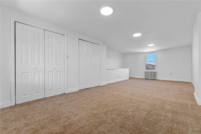 basement with carpet and radiator heating unit