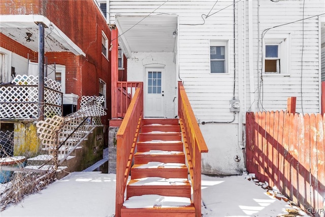 view of snow covered property entrance