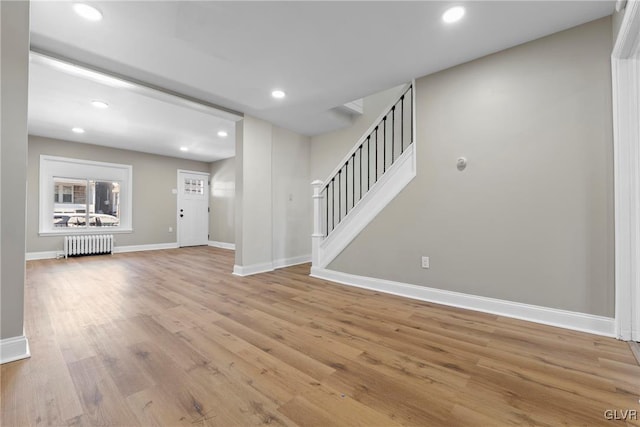 interior space featuring light wood-type flooring and radiator heating unit