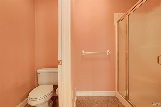 bathroom featuring toilet and walk in shower