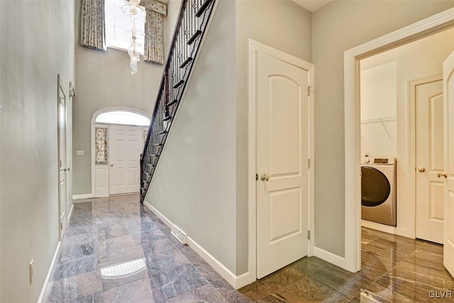 interior space featuring washer / dryer and a healthy amount of sunlight