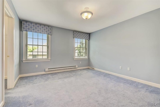 carpeted empty room with baseboard heating and a healthy amount of sunlight