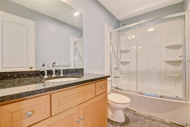 full bathroom with toilet, vanity, and shower / bath combination with glass door