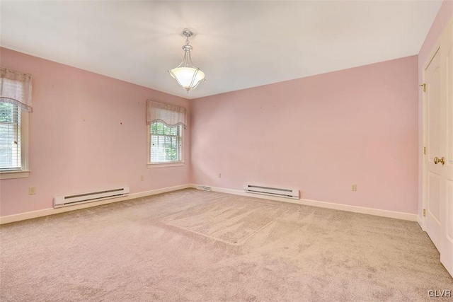 spare room with a baseboard radiator, a wealth of natural light, and carpet