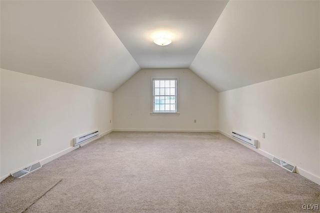 bonus room with a baseboard radiator, carpet, and lofted ceiling