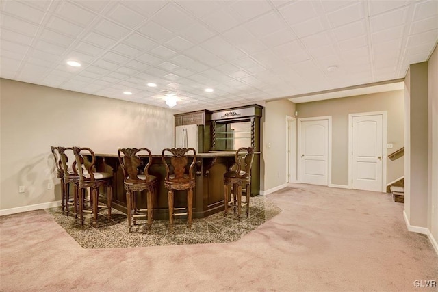 bar featuring carpet flooring and white refrigerator