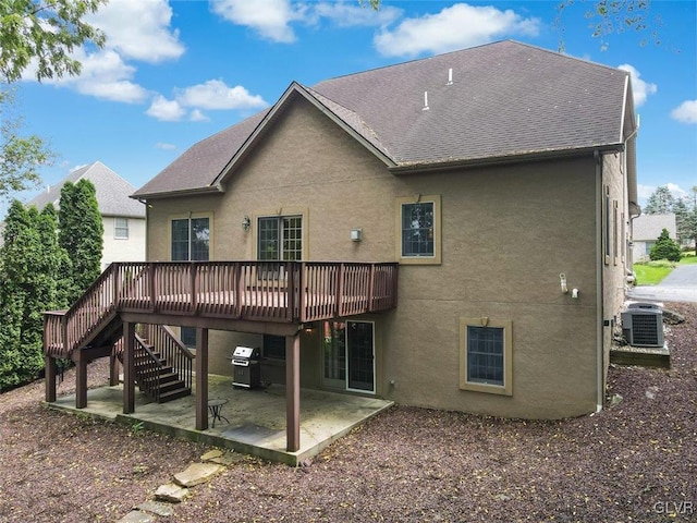 rear view of house with central air condition unit, a patio area, and a deck