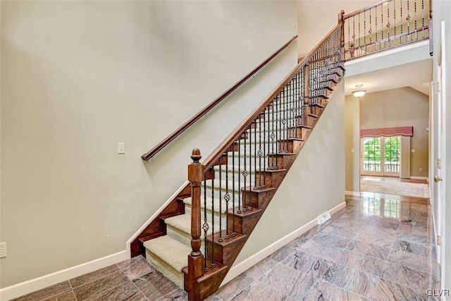 stairway with a towering ceiling