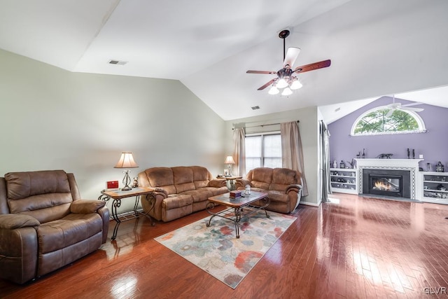 living room with vaulted ceiling, a wealth of natural light, ceiling fan, and wood-type flooring