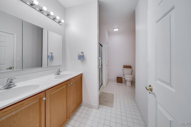 bathroom with toilet, vanity, an enclosed shower, and tile patterned flooring