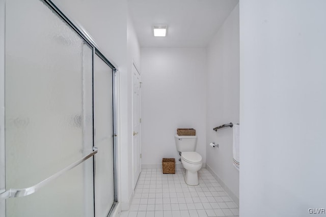 bathroom featuring toilet, tile patterned flooring, and an enclosed shower