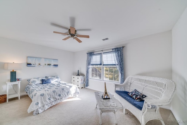 bedroom with ceiling fan and light carpet