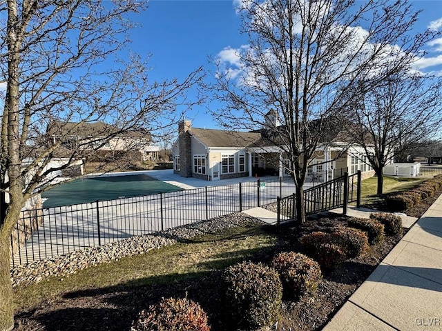 view of home's exterior with a covered pool and a patio area