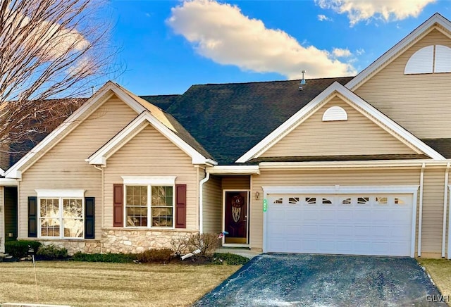 view of front of house with a garage and a front lawn