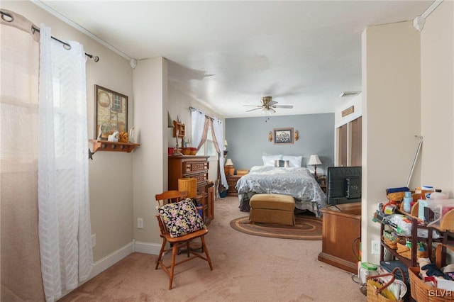 carpeted bedroom featuring ceiling fan, visible vents, and baseboards