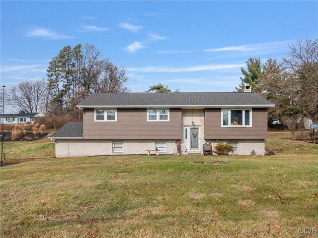 bi-level home with a front lawn