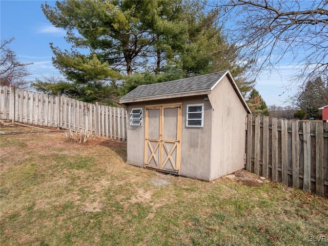 view of shed with a fenced backyard