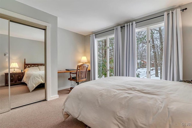 bedroom featuring carpet flooring, a closet, and built in desk