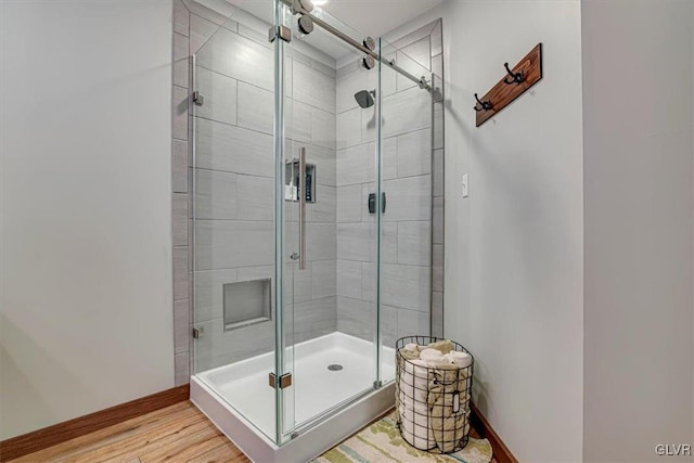 bathroom featuring wood-type flooring and walk in shower