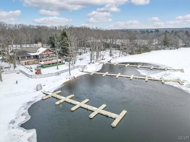 snowy aerial view featuring a water view