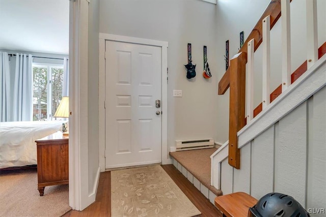 doorway with baseboard heating and light wood-type flooring