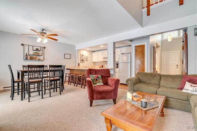 living room featuring light carpet and ceiling fan