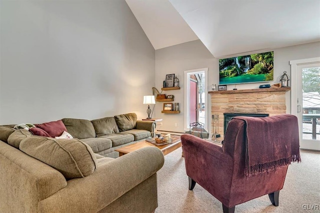 living room featuring light carpet, a stone fireplace, and vaulted ceiling