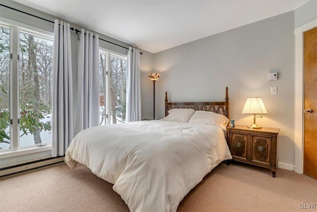 carpeted bedroom featuring a baseboard radiator