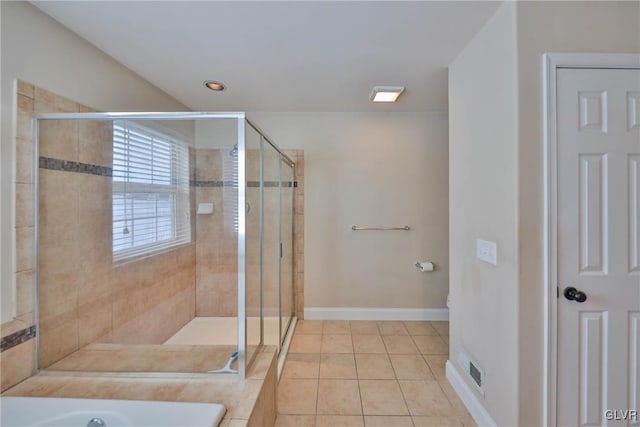 bathroom featuring tile patterned flooring and shower with separate bathtub