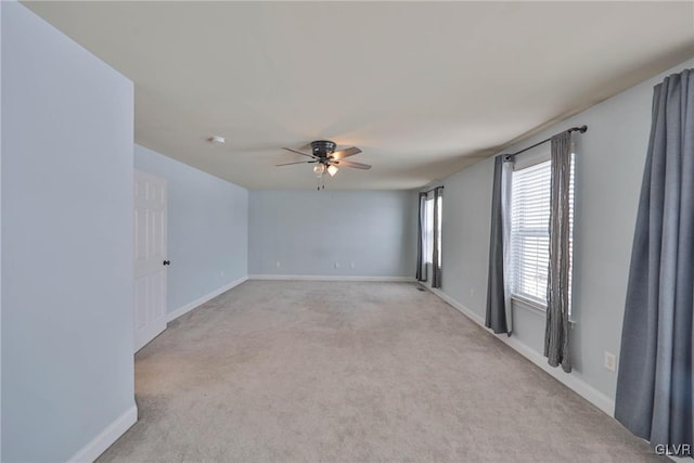 unfurnished room featuring light carpet and ceiling fan