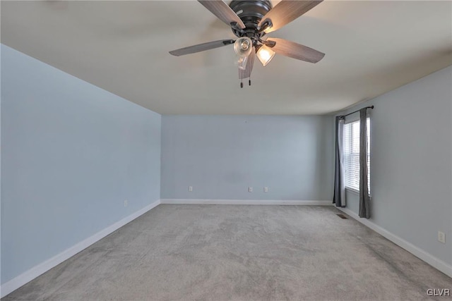 carpeted spare room featuring ceiling fan