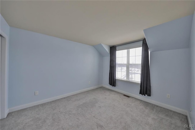 bonus room featuring light colored carpet and lofted ceiling