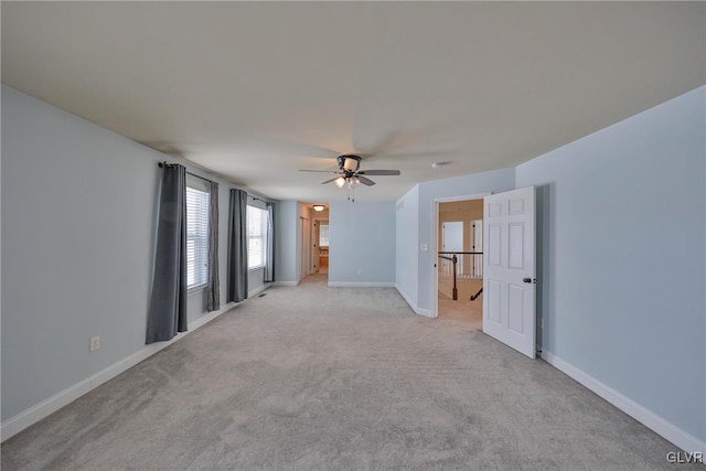 empty room with ceiling fan and light colored carpet