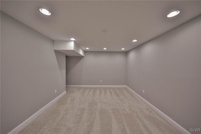 basement featuring light carpet