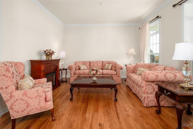 living room with light hardwood / wood-style floors and ornamental molding