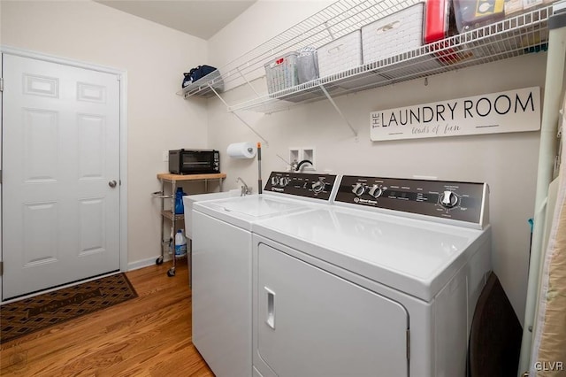 washroom featuring light hardwood / wood-style floors and washer and clothes dryer