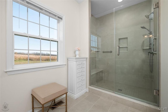 bathroom featuring walk in shower and tile patterned flooring