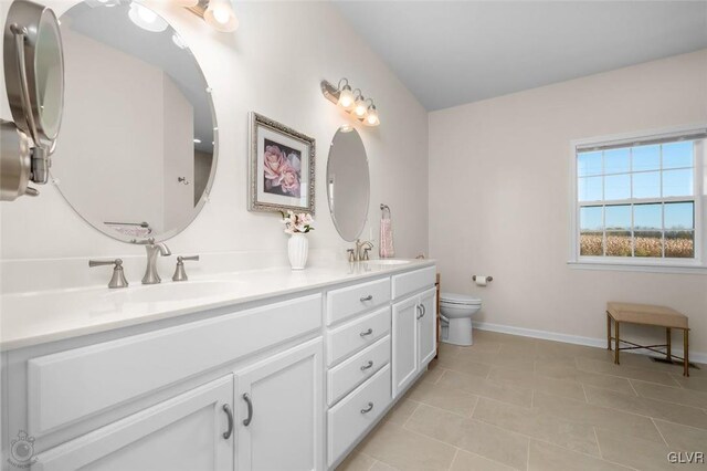 bathroom featuring vanity, toilet, and tile patterned floors