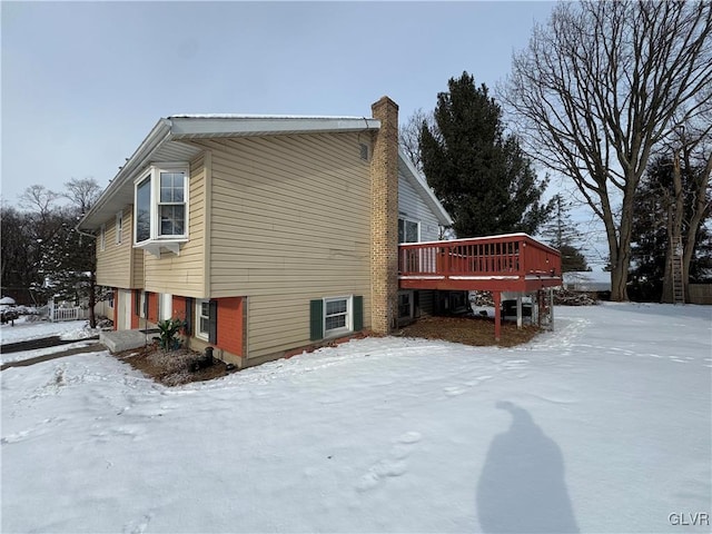 view of snowy exterior with a deck