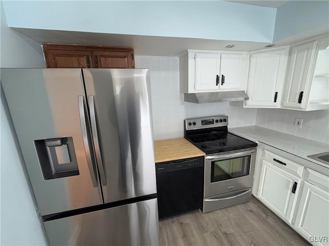 kitchen with backsplash, white cabinets, stainless steel appliances, and light wood-type flooring