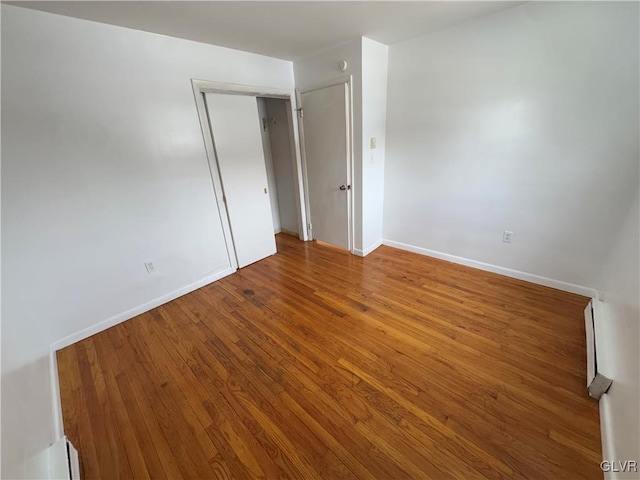 unfurnished bedroom with hardwood / wood-style flooring