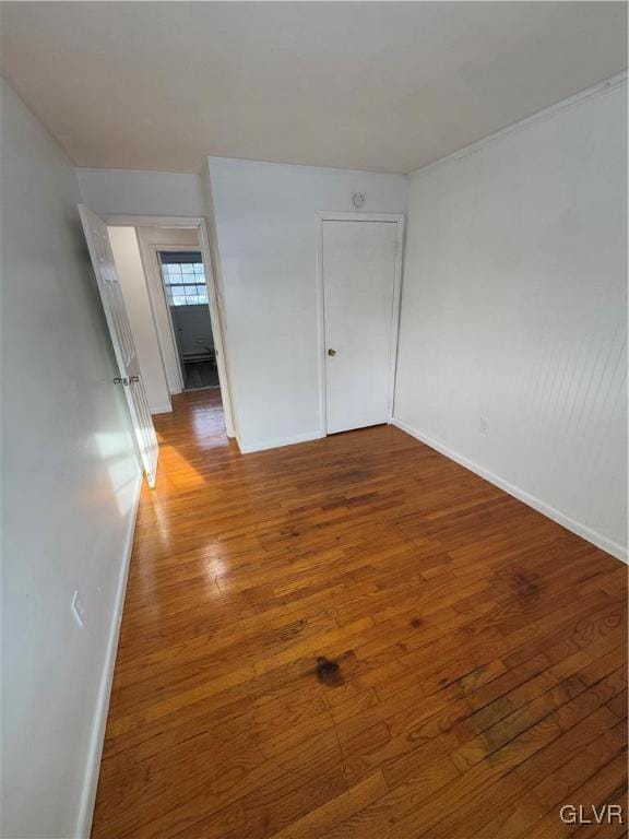 unfurnished room with wood-type flooring