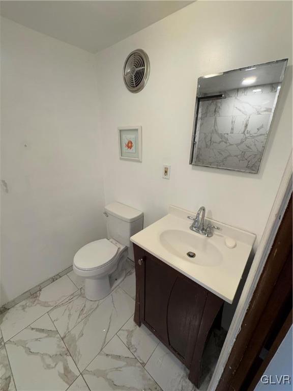 bathroom with toilet and vanity