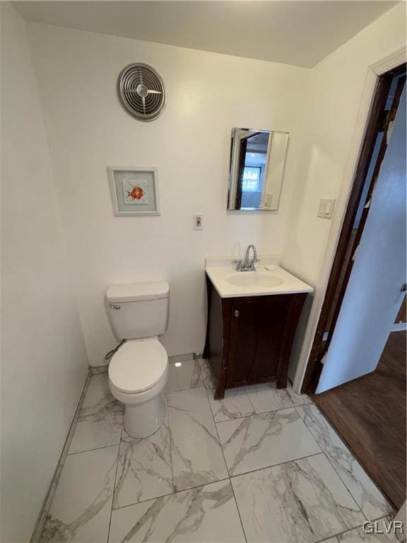 bathroom featuring toilet and vanity