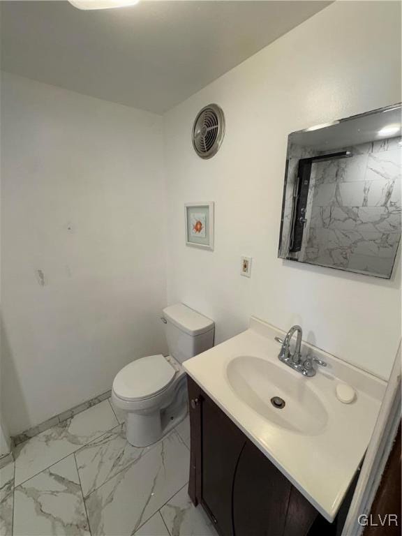 bathroom featuring toilet and vanity