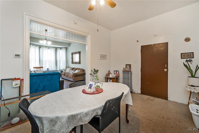 dining area featuring ceiling fan with notable chandelier