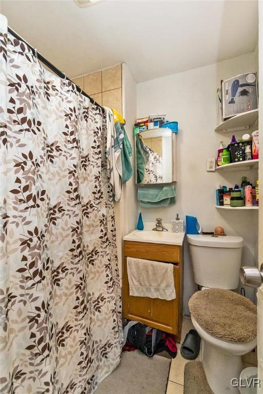 bathroom with sink, curtained shower, and tile patterned floors